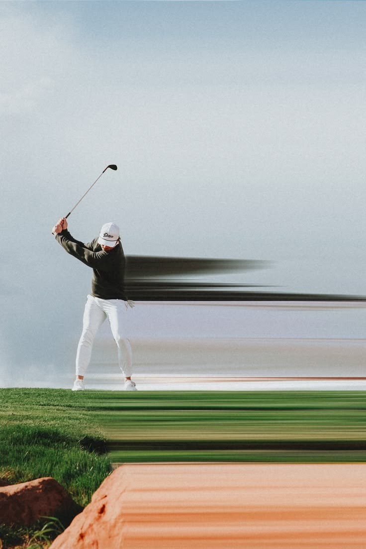A golfer at the top of the backswing on a coastal course