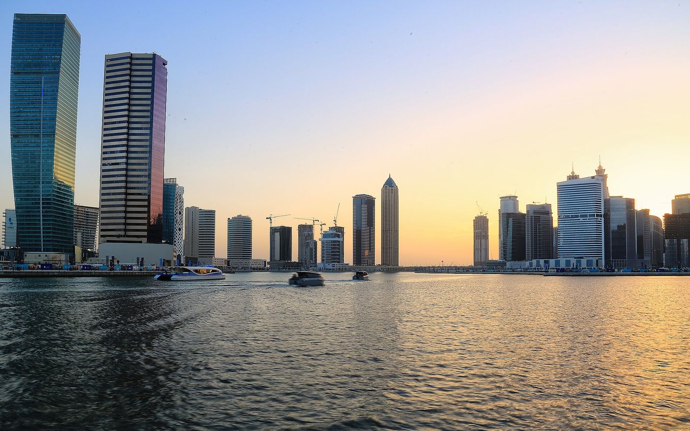 Business Bay towers along the Dubai Water Canal at sunset, Dubai, UAE