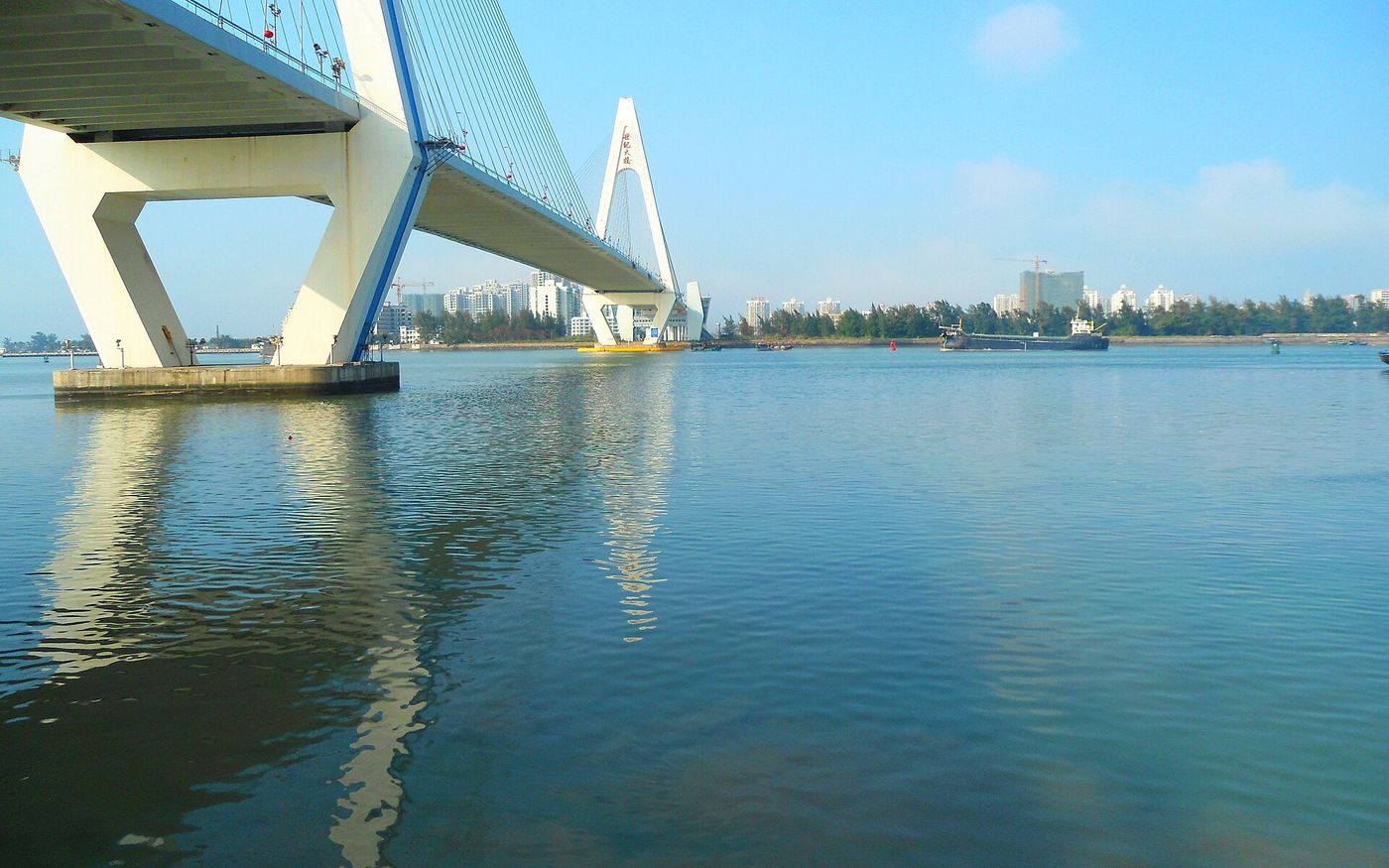 Haikou Century Bridge over the blue water of Haikou Bay, Hainan, China