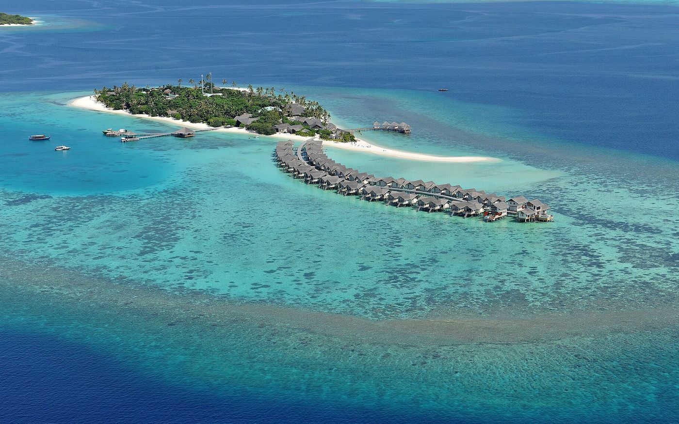 Aerial view of a resort island with overwater villas, Raa Atoll, Maldives