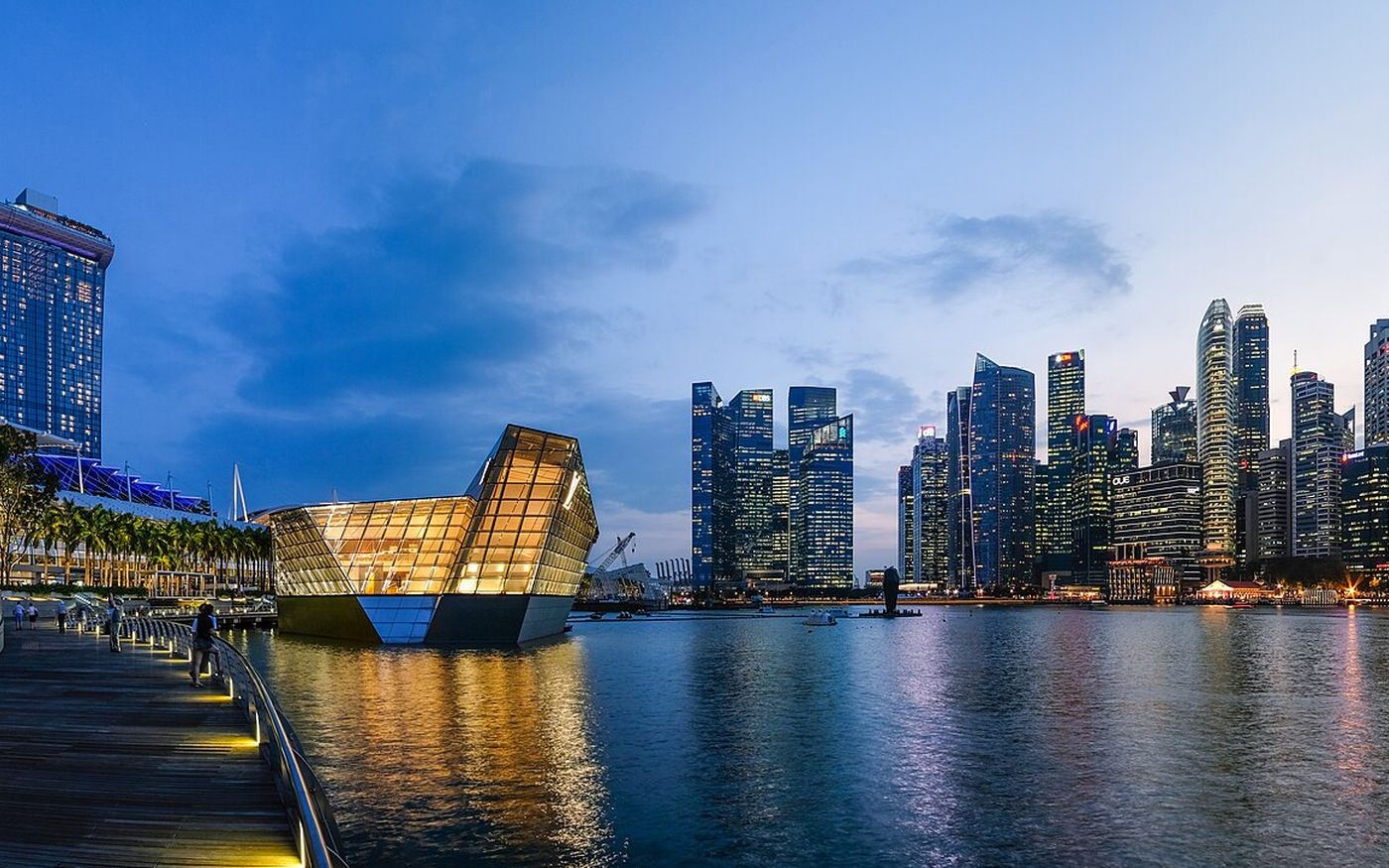Marina Bay, Singapore, at dusk with the skyline reflected in the water
