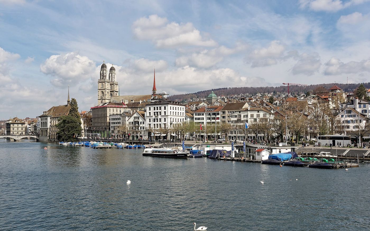 The Grossm&uuml;nster towers above the Limmat river in the old town of Zurich, Switzerland