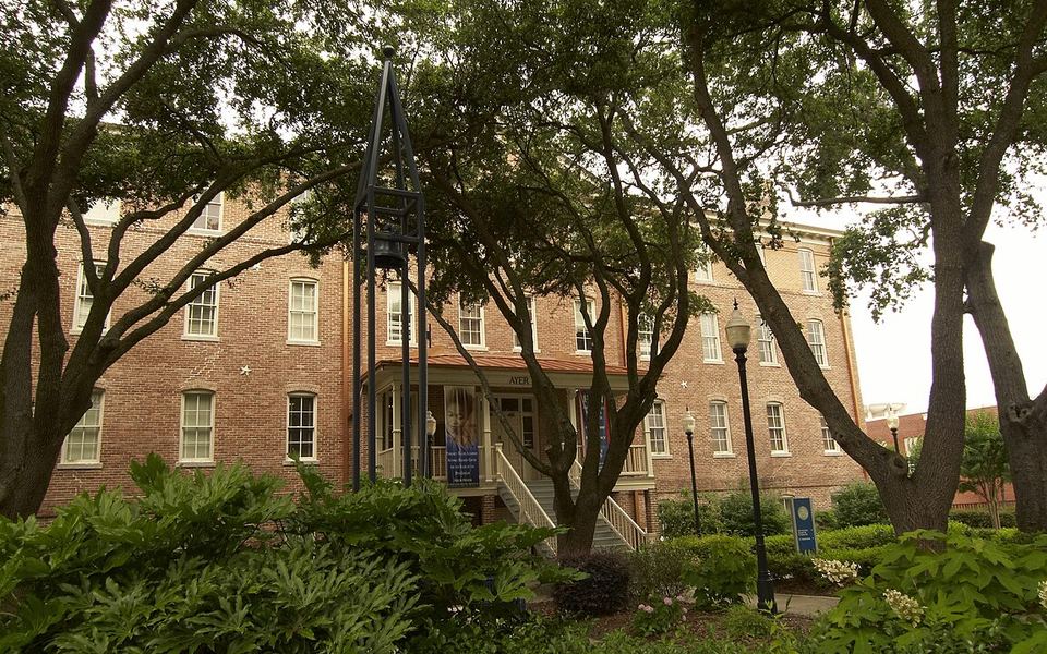 Ayer Hall, a red-brick building behind trees and gardens on Jackson State University’s campus in Jackson, Mississippi