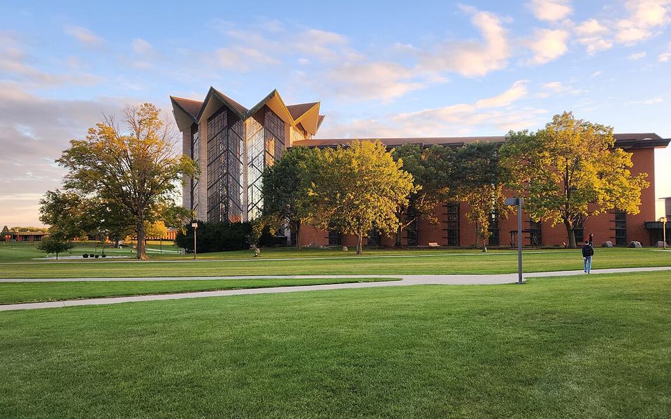 The Chapel of the Resurrection on Valparaiso University&rsquo;s campus in Valparaiso, Indiana, behind autumn trees and the campus lawn in early-evening light
